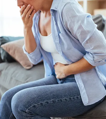 Woman experiencing stomach discomfort during weight loss medication